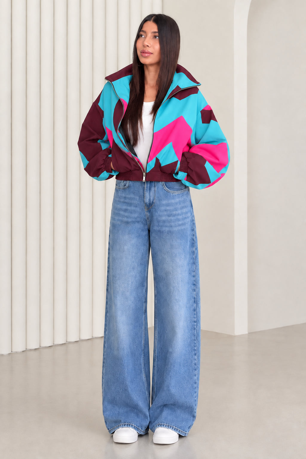 Woman wearing burgundy and turquoise colorblock retro bomber jacket