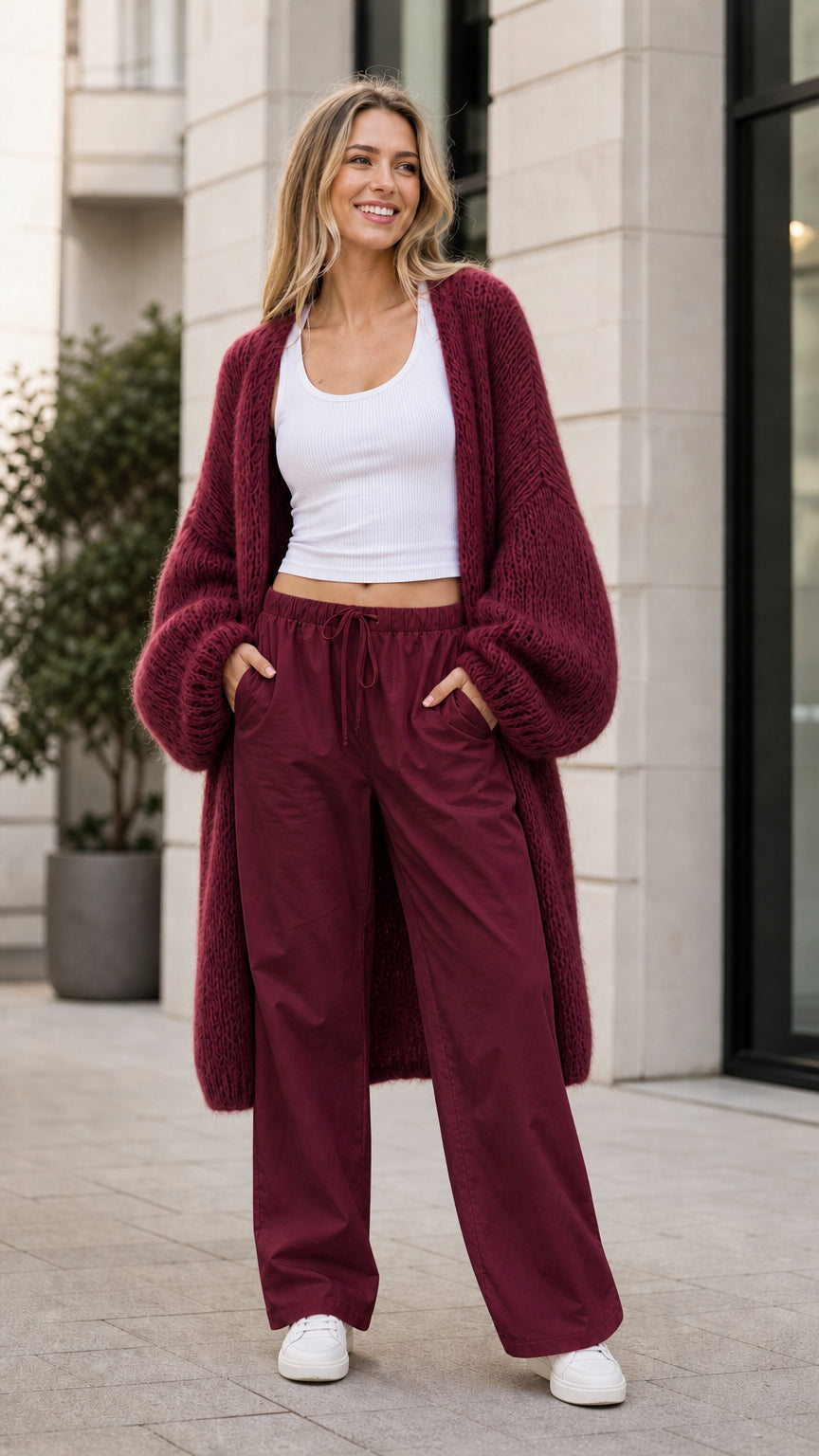 Model wearing burgundy oversized knit cardigan