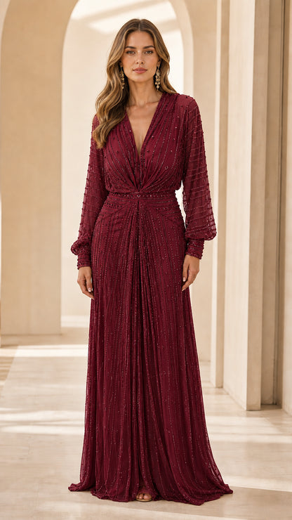 Front view of model in burgundy beaded evening dress