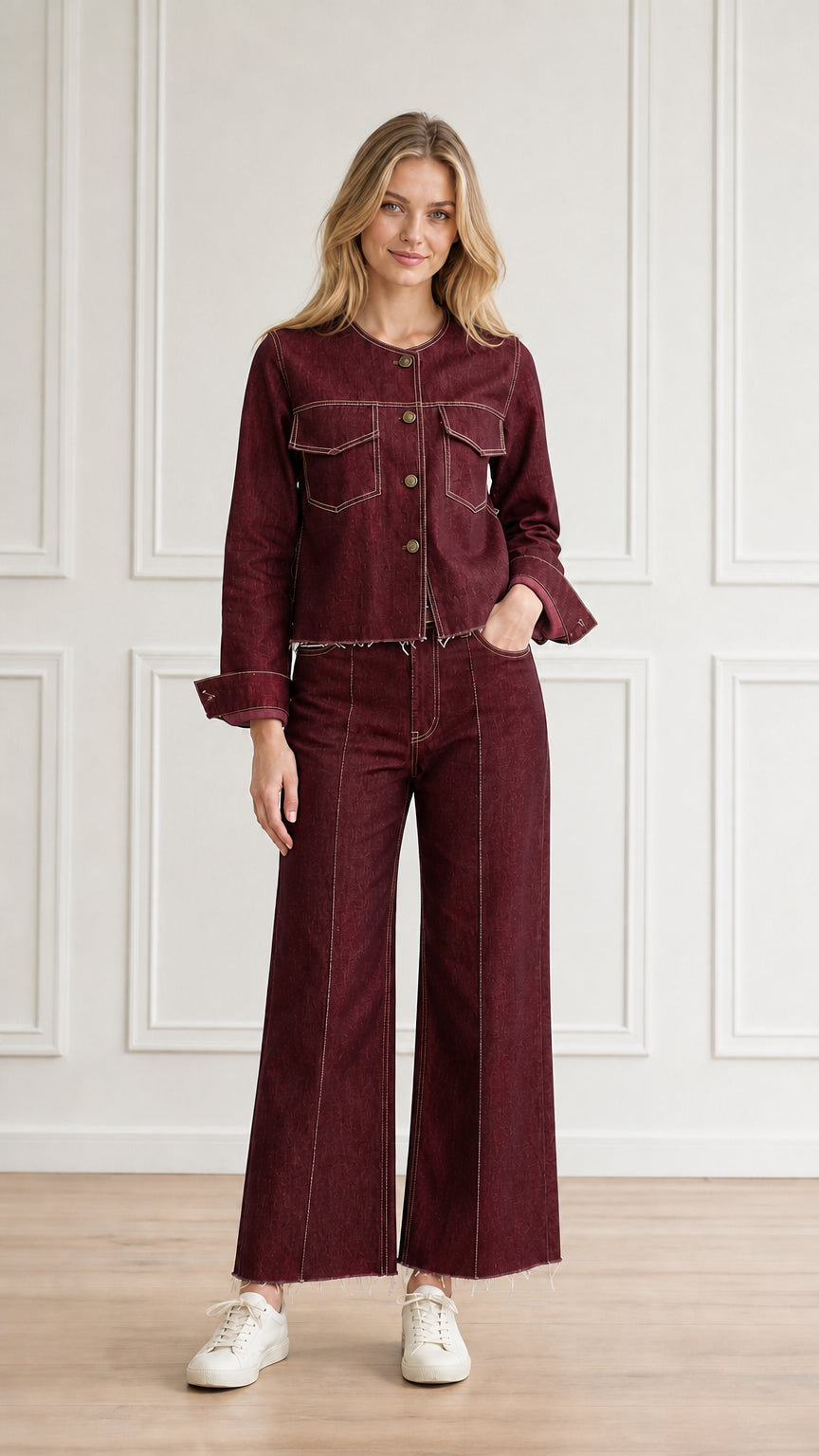 Model wearing burgundy red denim jacket and matching wide-leg trousers