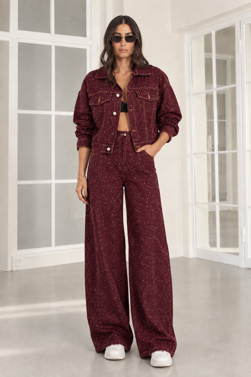Model wearing burgundy wine rhinestone denim cropped jacket and wide-leg jeans set