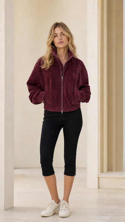 Woman wearing burgundy full-zip bomber jacket