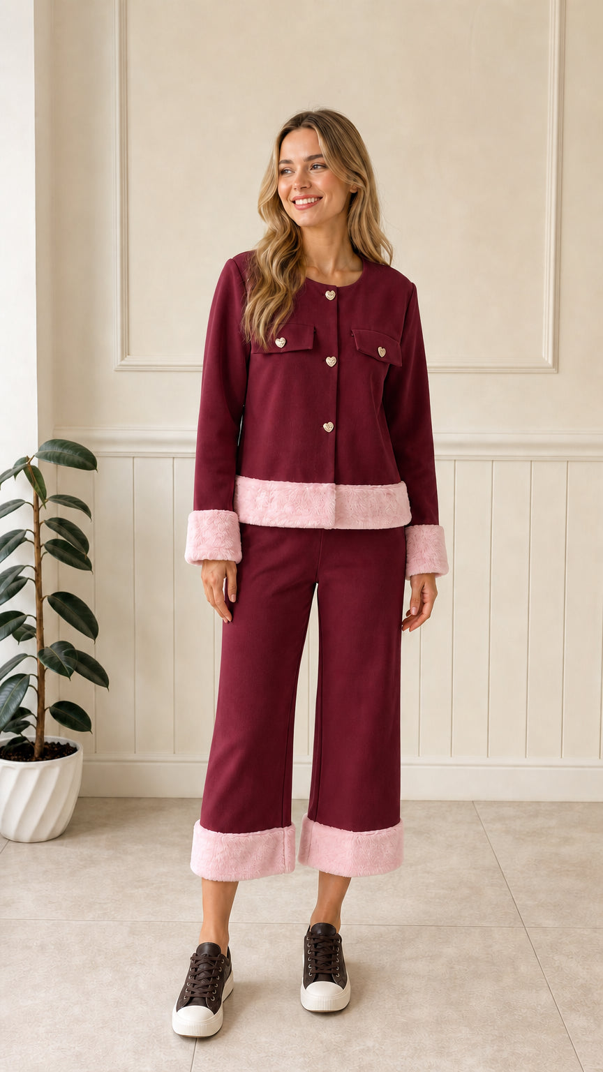 Front view of woman wearing burgundy jacket with pink faux fur trim and matching pants