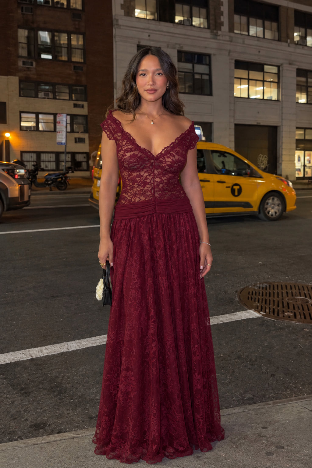 Woman wearing burgundy wine red lace formal gown