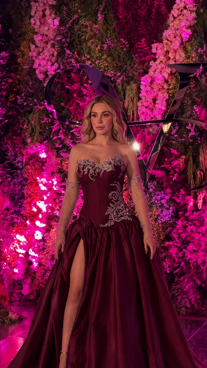 Front view of deep burgundy wine strapless corset evening gown with high slit