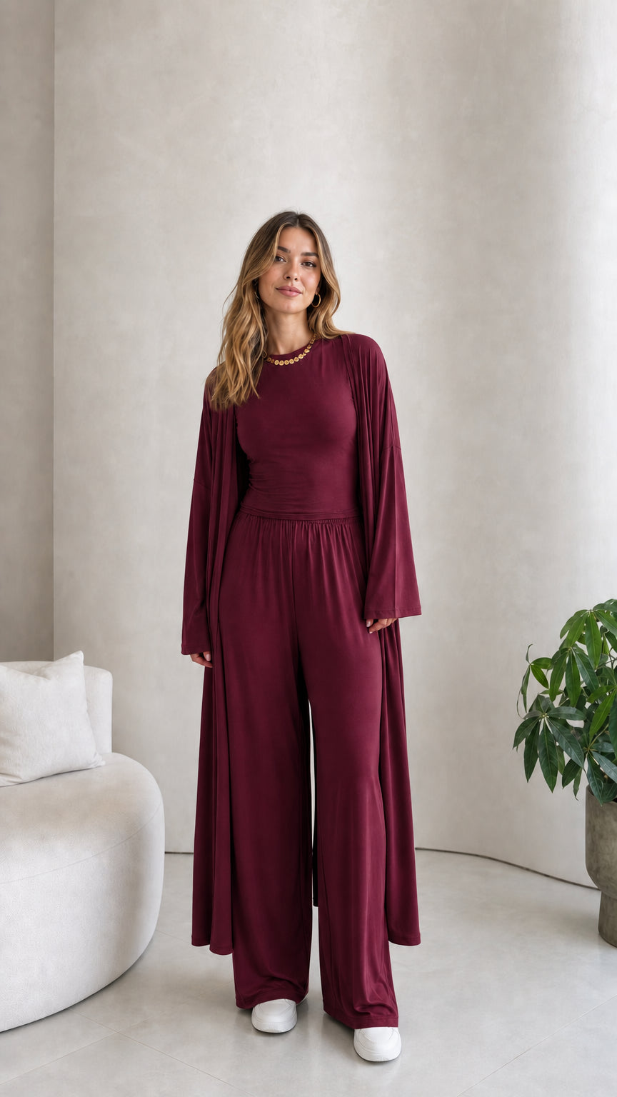 Front view of model wearing the 3-piece duster cardigan and pants set in burgundy wine