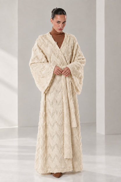 Front full view of woman wearing beige textured chevron fringe maxi wrap robe