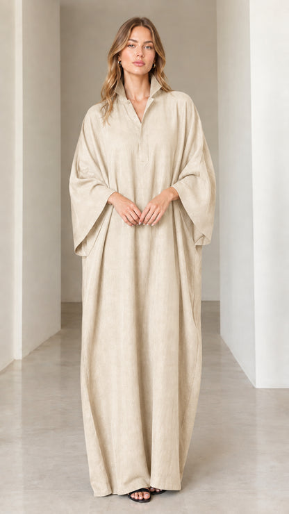 Model wearing elegant beige cream oversized collared kaftan dress