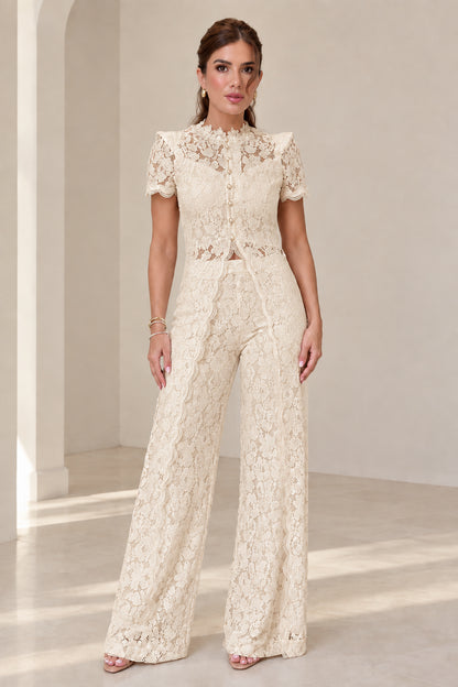 Model wearing champagne cream floral lace top and wide-leg pants set