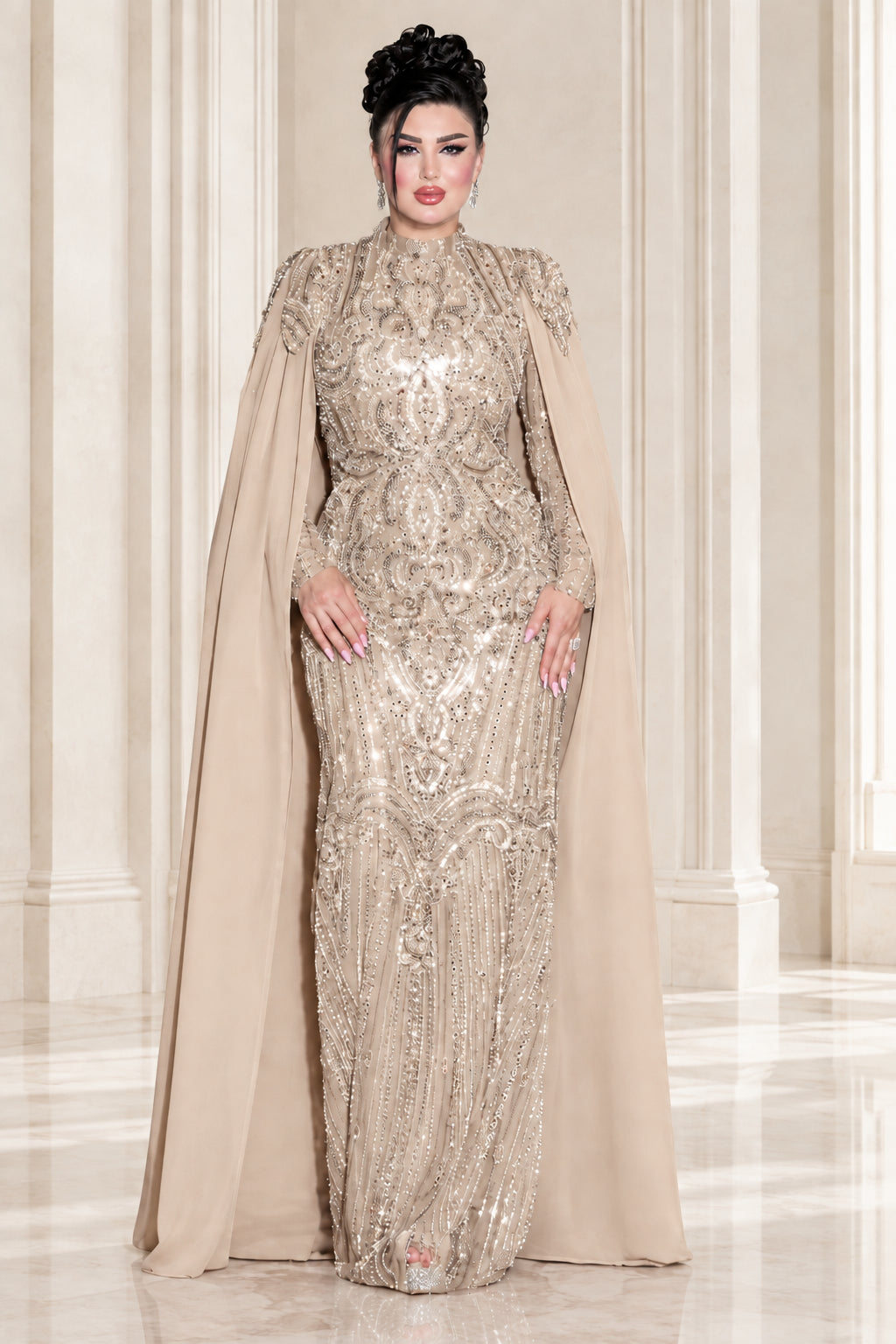Model wearing champagne gold embellished high neck cape evening gown