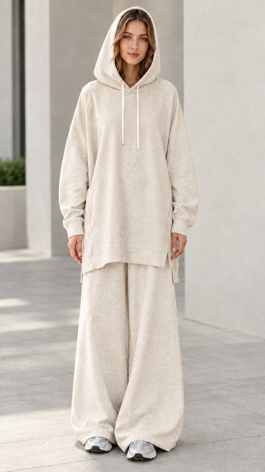 Woman wearing oatmeal beige longline tunic hoodie and wide-leg matching sweatsuit set