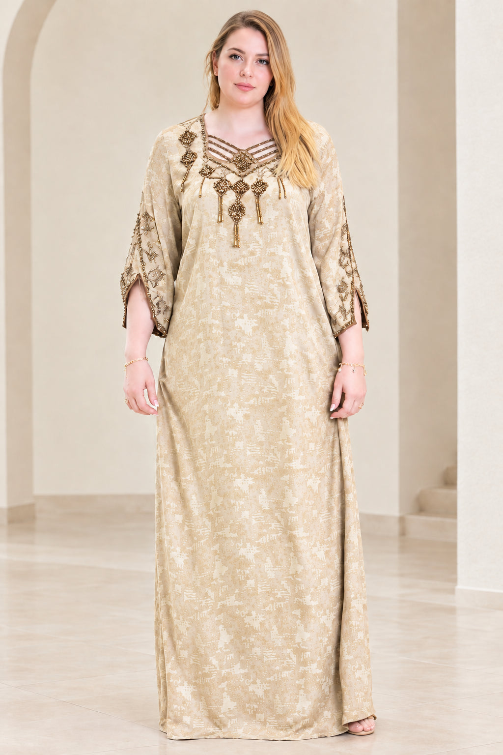 Front view of woman wearing champagne beige beaded strappy neckline kaftan dress