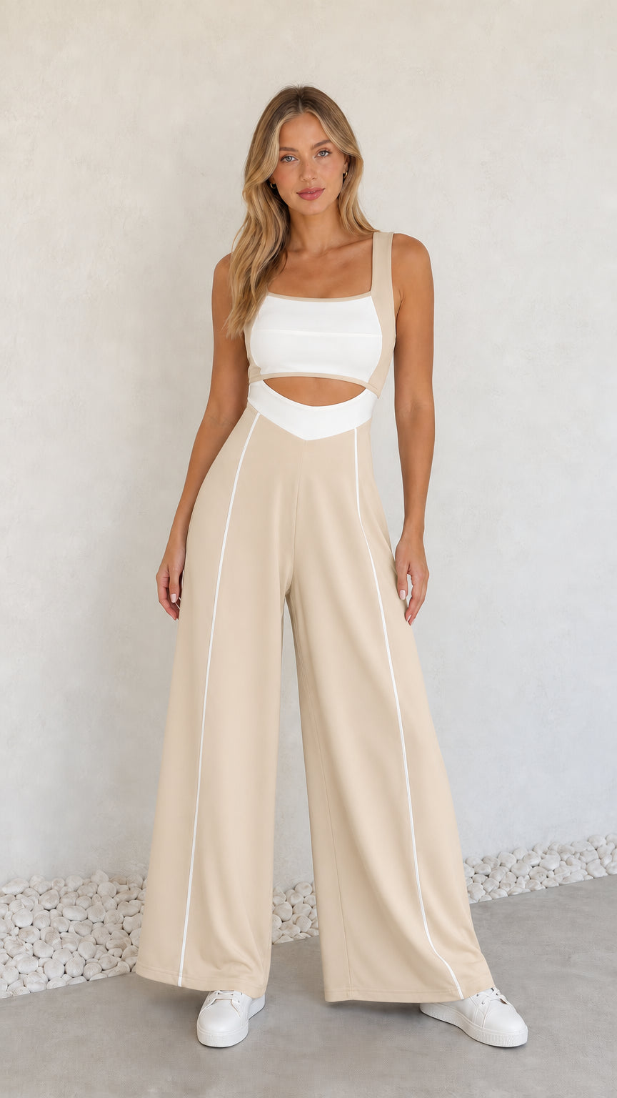Model wearing beige colorblock cutout wide-leg jumpsuit with white piping