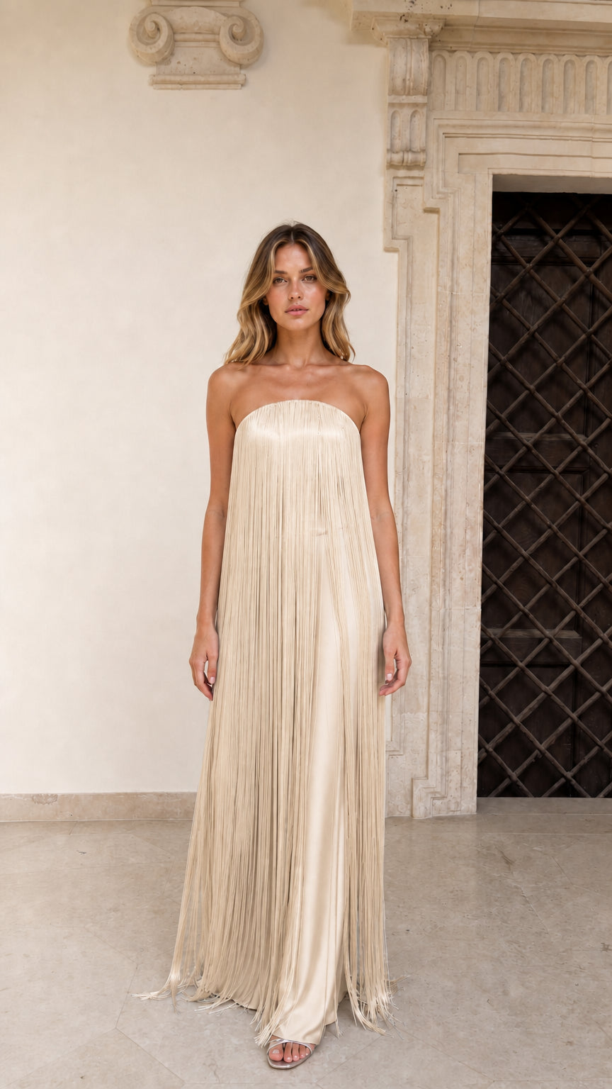 Model wearing Champagne strapless fringe evening maxi gown