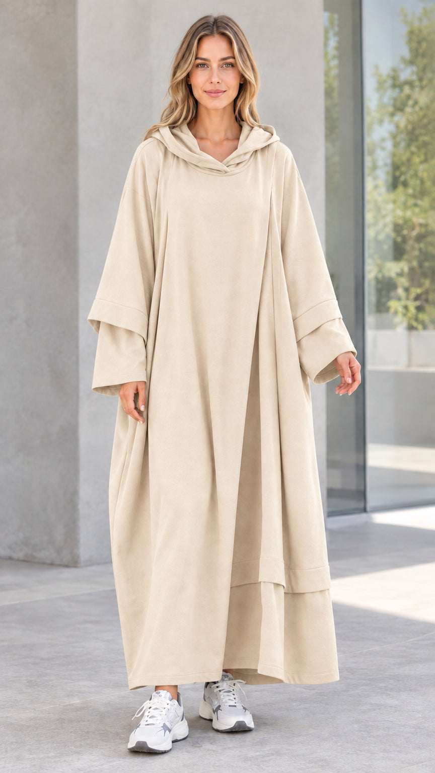 Front view of woman wearing beige oversized hooded maxi dress