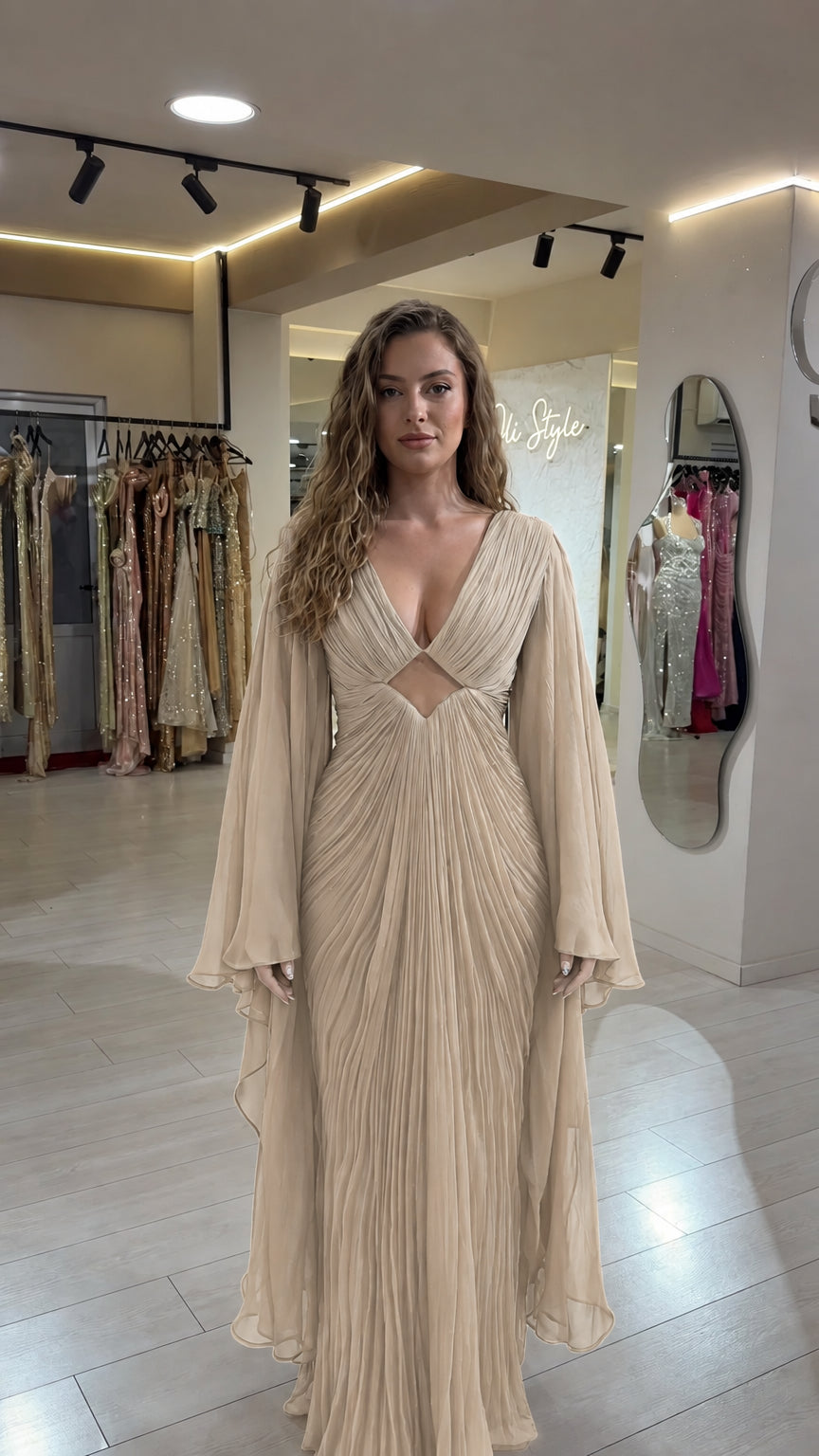 Champagne beige pleated maxi gown with plunging neckline and cape sleeves