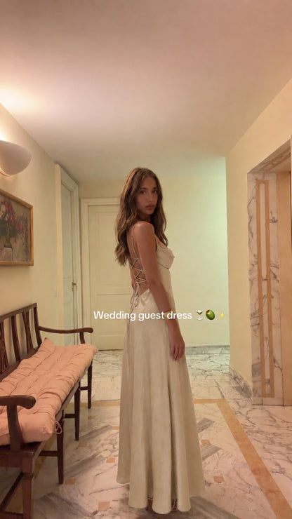Model wearing Champagne ivory satin cowl neck backless maxi dress