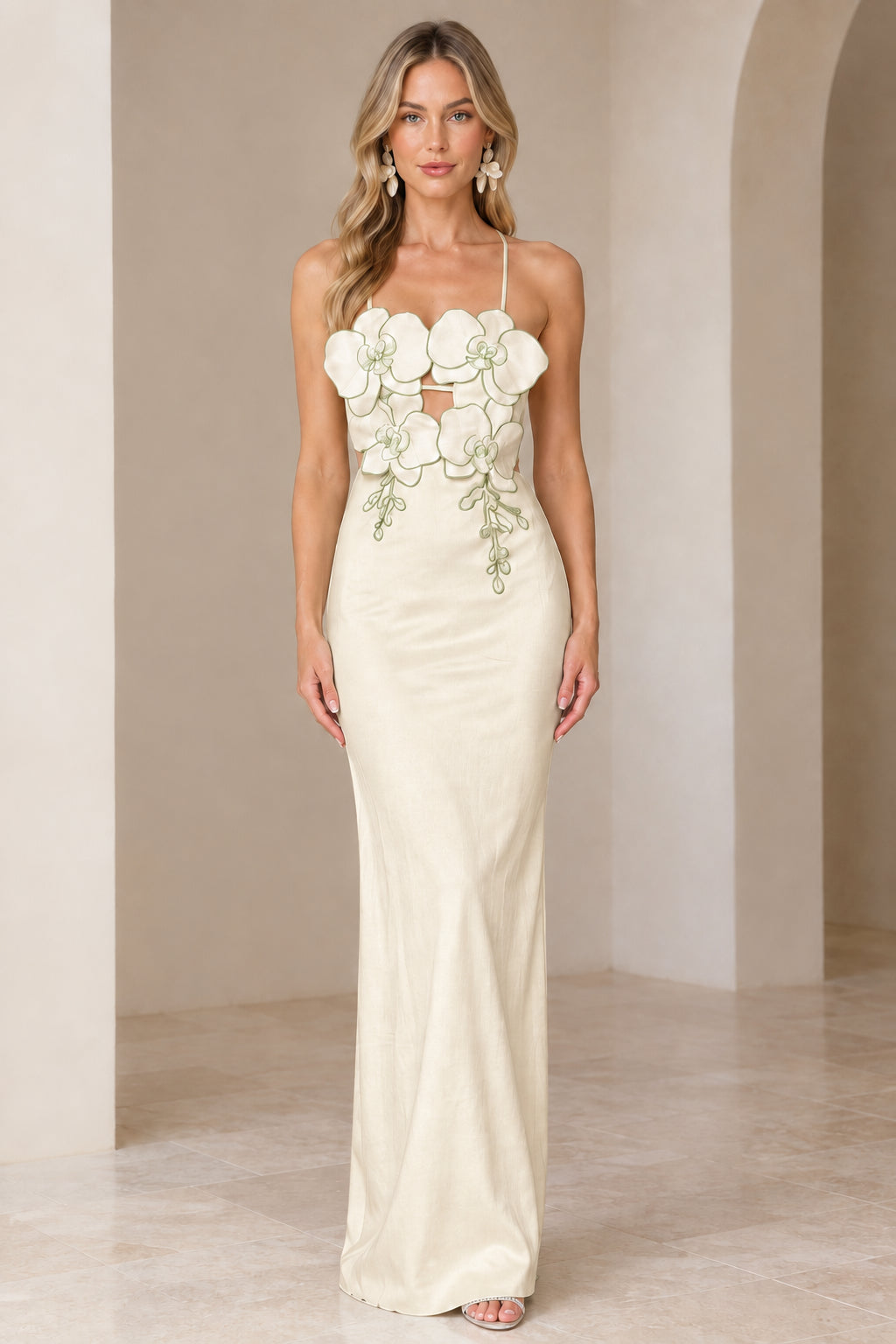 Front view of model wearing Champagne ivory 3D floral maxi gown