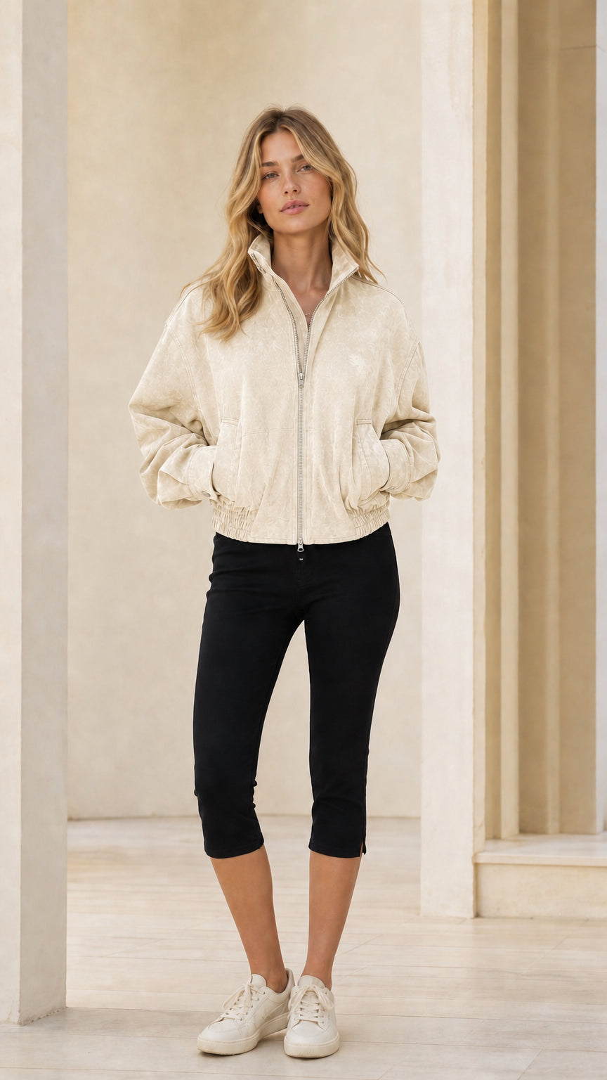 Woman wearing beige full-zip bomber jacket