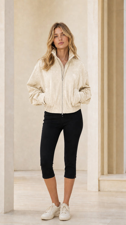 Woman wearing beige full-zip bomber jacket