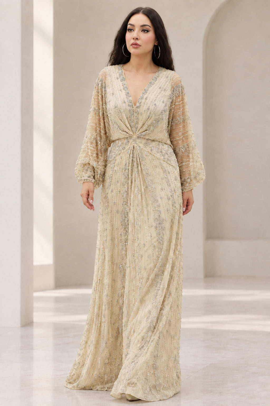 Front view of Champagne gold embellished long sleeve maxi evening gown