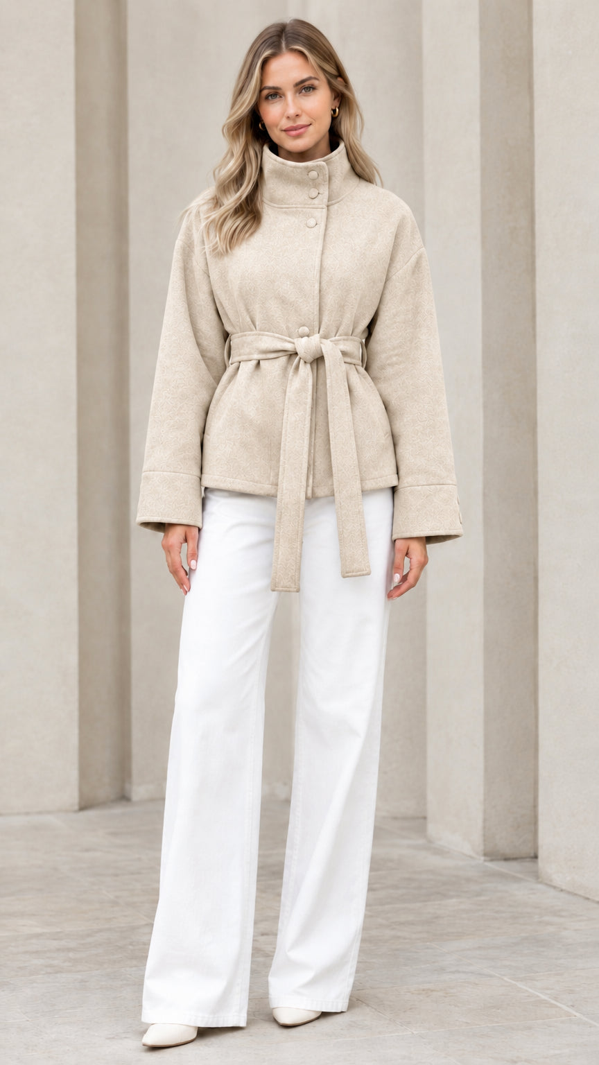 Front view of model wearing beige stand collar belted short coat